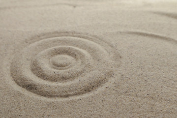 Fototapeta na wymiar Patterns drawn on yellow sand