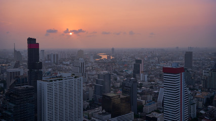 sunset skyline in bangkok with river and cityscape