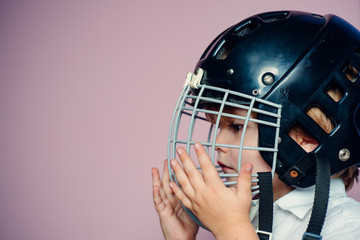 Protective grid on face. Sport equipment. Hockey or rugby helmet. Sport childhood. Future sport star. Sport upbringing and career. Boy cute child wear hockey helmet close up. Safety and protection