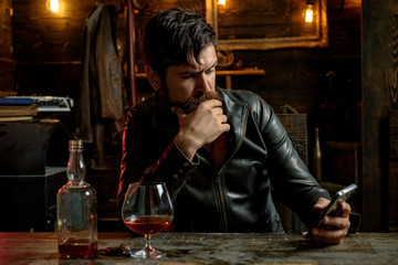 Portrait of stylish man beard. Vintage barbershop, shaving. Men's beauty, fashion. Male beard and mustache. Sexy male, macho, long beard. Man is thinking. Answering on his phone.