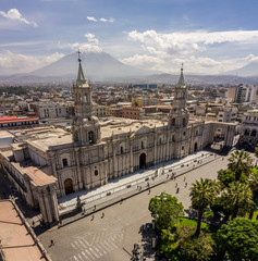 Aerial drone view of Arequipa main square and cathedral church, with the Misti volcano as background.