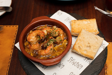 Shrimp hot spice herb ingredient bread with secret recipe sauce on plate course set of Spanish food Cuisine culinary which a bit hot and unique taste on wooden table.