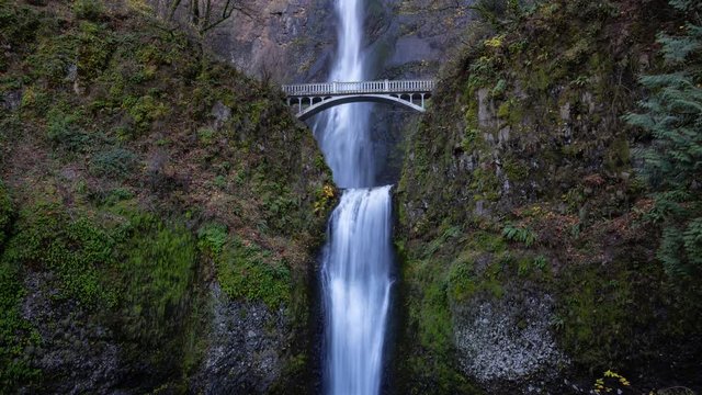 Beautiful view of a bridge going over a river with Multnomah Falls in the background. Located near Portland, Oregon, United States. Cinemagraph