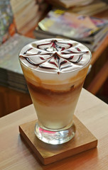 A Cup of  latte art coffee on wooden table