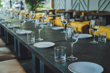 Glass goblets on the table. Served table. Table setting