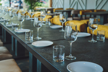Glass goblets on the table. Served table. Table setting
