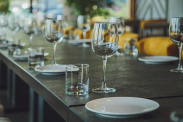 Glass goblets on the table. Served table. Table setting