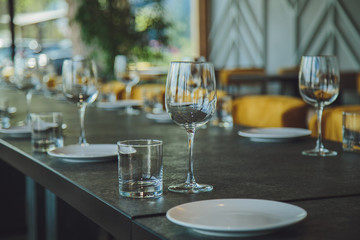 Glass goblets on the table. Served table. Table setting