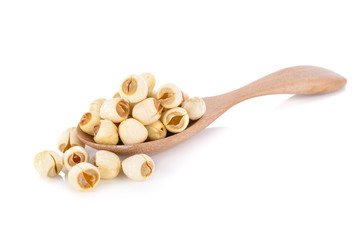dried lotus seeds on wooden spoon with white background