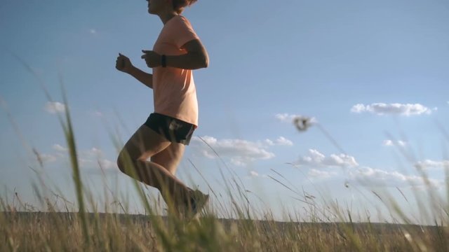 Young woman runner training in summer. Jogging outdoor. Morning running concept