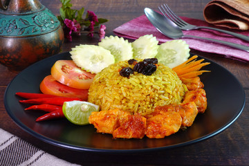 Briyani rice with Sweet spicy chicken curry (Nasi Briyani dengan Ayam Masak Merah), the famous Malaysian cuisine. Halal food.