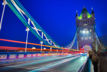 Vehicles pass over Tower Bridge across the River Thames in London, UK.