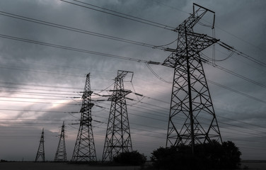  high-voltage  power lines at sunset.