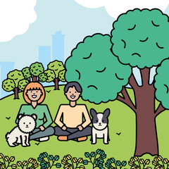 young couple with little dogs in the park