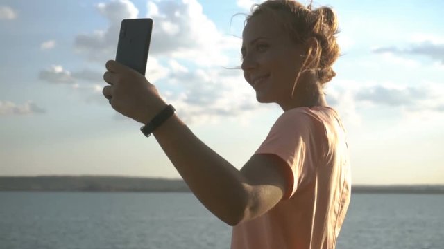 Woman taking selfie on her phone in beautiful nature. Travel vacation.