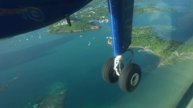 Passenger view of a dhc twin otter flying over the Caribbean island of Grenada