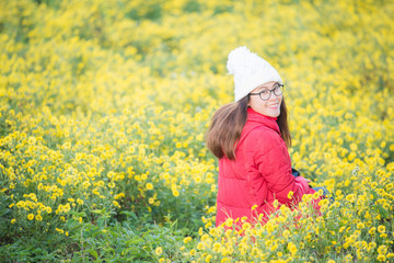 Fototapeta premium Portrait of Asian woman enjoying her holiday in Chrysanthemum flowers field on Doi Sango mountain in Chiang Saen district of Chiang Rai province, Thailand.
