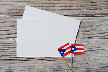 Fototapeta na wymiar Puerto Rico independence day. day of constitution 25 July. the concept of veterans Day or memorial . mini flags with sheets of white paper on white wooden background.mockup, copy space.