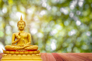 Golden Buddha image under the Bodhi leaf, natural background