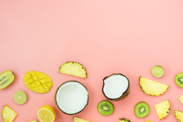 Table top view fruit tropical with spring summer holiday & vacation background concept.Arrangement sliced various pineapple kiwi mango lemon and lime coconut on pink paper.flat lay & copy space.