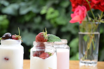 Healthy breakfast - granola, strawberries, cherry, honeysuckle berry, nuts and yogurt in a bowl....