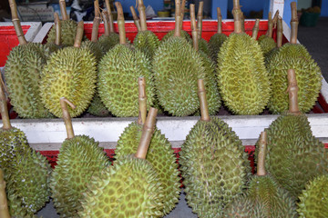 Durian on the table;Durian on shelves;Durian at market