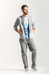 Fototapeta premium Handsome stylish man on light background