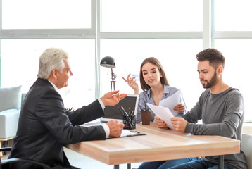 Couple meeting with notary public in office