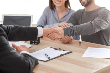 Man shaking hands with notary public in office