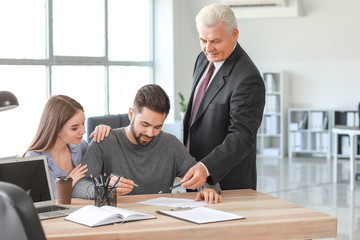 Couple signing documents at notary public office