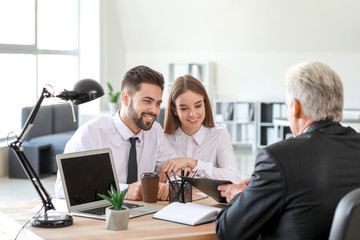 Couple meeting with notary public in office