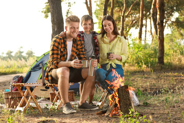 Happy family spending weekend in forest