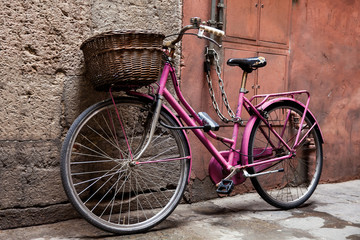 Naklejka na ściany i meble Parked bicycle at the beautiful streets of Pisa