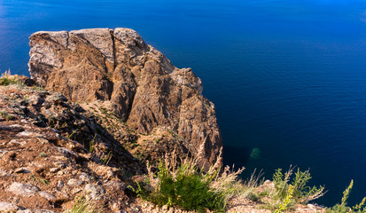 grass on the rock and blue lake Baikal