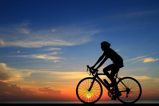 Silhouette  cycling  on blurry sunrise  sky   background.