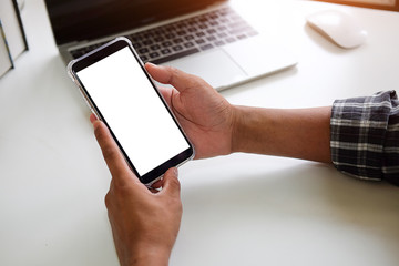 Cropped shot view of man hands holding smart phone with blank copy space screen for your text message or information content, female reading text message on cell telephone during in urban setting. 