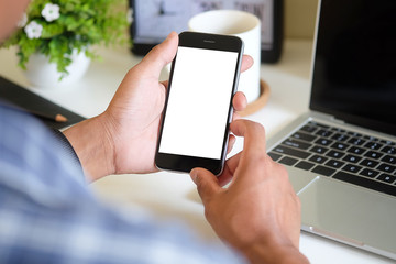 Cropped shot view of man hands holding smart phone with blank copy space screen for your text message or information content, female reading text message on cell telephone during in urban setting. 
