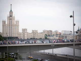 Cityscape: Moscow views. View of the bridge over the Moscow river from Zaryadye Park. A lot of people on the observation deck over the river on a cloudy summer day in Moscow.  