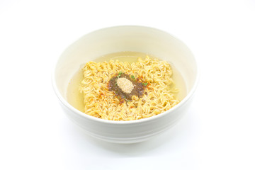 Famous home made asian instant noodle floating on boiled water with unhealthy seasoning powder (monosodium glutamate) in a ceramic bowl on white background. Horizontal shot.