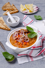 Thick soup with lentils, slices of meat and vegetables