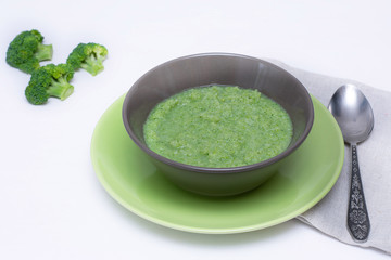 Vegetarian soup of broccoli puree on a white background. The concept of healthy eating.