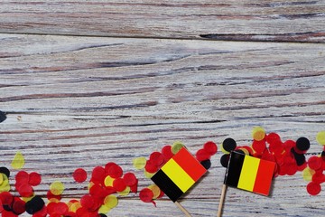 national day of Belgium , July 21. national Belgian festival. the concept of celebration, fun, patriotism and freedom. mini flags and confetti on white wooden background. horizontal pfoto