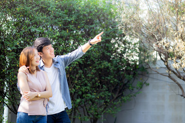 Beautiful portrait couple looking each others eyes and smiling with happy, young asian man and...