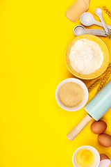 Baking or cooking ingredients on yellow background, flat lay