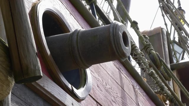 Cannon protruding out the side of a pirate ship. CLOSE UP