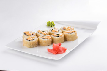 tempura sushi maki roll with shrimp, avocado and mayo on top isolated on white background