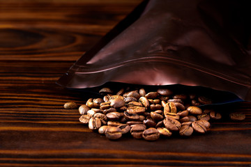 Coffee grains were scattered from a package on wooden boards