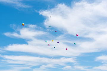 balloons with greeting cards in the sky