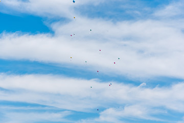 balloons with greeting cards in the sky