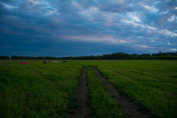 landscape, blue thunderstorm and a large green field
